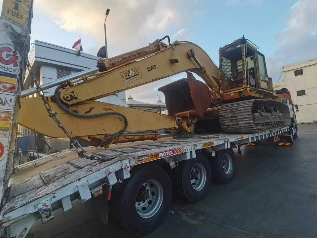Excavator transported on a flatbed trailer